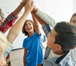 school pupils joining hands